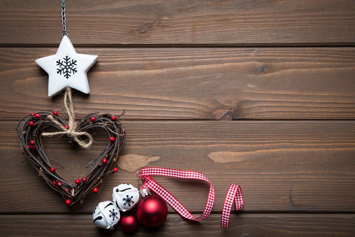 Christmas decorations arranged on weathered brown wooden planks, captured with natural even lighting and medium depth of field in a left-heavy composition
