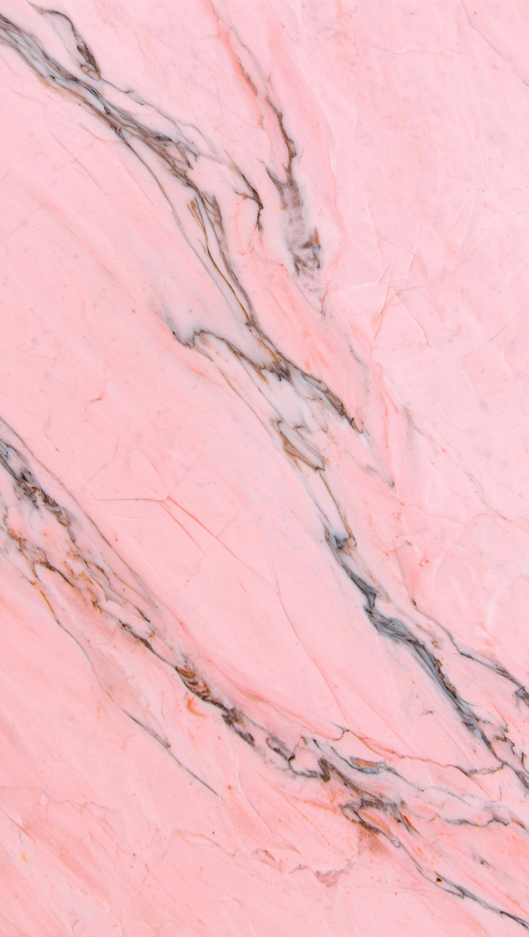 A close-up, fine art photography of pink marble with gray and white veins
