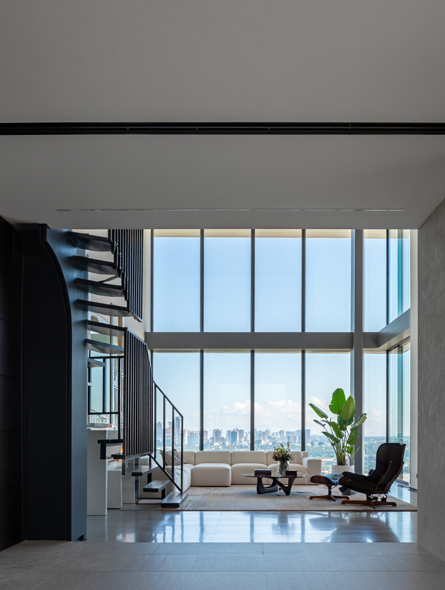Minimal interior with a high ceiling and large windows offering a panoramic view of a cityscape with numerous buildings under a clear sky